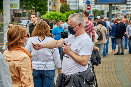 June 7 2020 Minsk Belarus An opposition blogger is broadcasting live on the street asking people questionsのeditorial素材