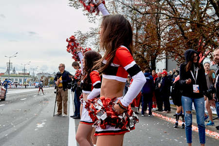 September 15, 2019 Minsk Belarus There are beautiful dancing cheerleaders with bows in their hands before the start of the raceのeditorial素材