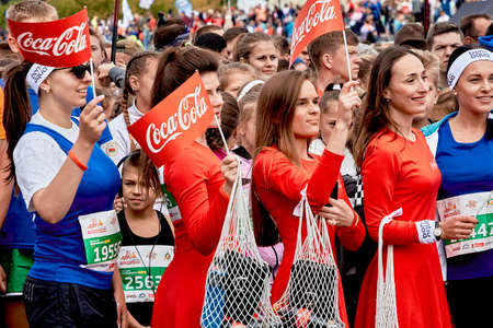 September 15, 2019 Minsk Belarus There are a lot of athletes with small flags who stand before the start of the marathonのeditorial素材