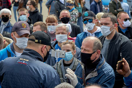 May 24 2020 Minsk Belarus There are a lot of masked people with phones in their hands who have gathered around the opposition leader to ask him questionsのeditorial素材