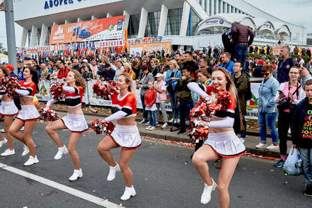 September 15, 2019 Minsk Belarus There are beautiful dancing cheerleaders with bows in their hands before the start of the raceのeditorial素材