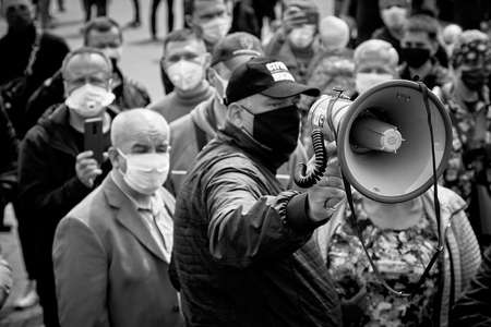 May 24 2020 Minsk Belarus Loudspeaker in the hand of the leader of the opposition, who stands among the people.In black and white image.のeditorial素材