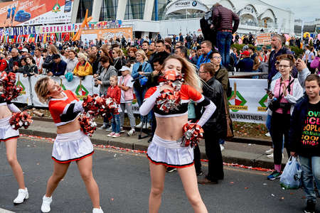September 15, 2019 Minsk Belarus There are beautiful cheerleaders with bows in their hands before the start of the raceのeditorial素材