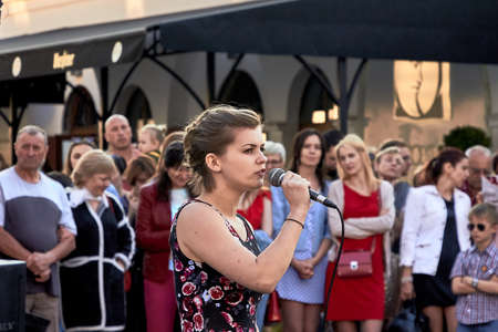 May 25, 2019 Minsk Belarus A theatrical performance in which a young Caucasian woman with a microphone sings in front of a crowd of peopleのeditorial素材