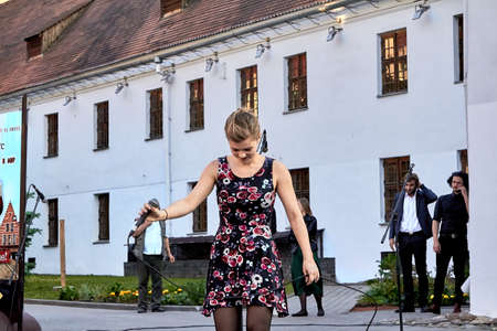 May 25, 2019 Minsk Belarus A theatrical performance in which a young woman with a microphone sings in the streetのeditorial素材