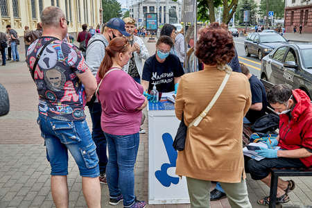 June 7 2020 Minsk Belarus A woman from the initiative group registers the signatures of the gathered peopleのeditorial素材