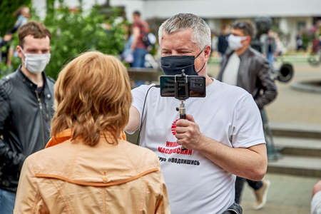 June 7 2020 Minsk Belarus A close up of an opposition blogger is broadcasting live on the street asking a woman questionsのeditorial素材