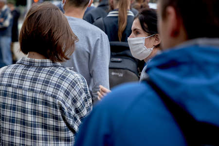 June 14 2020 Minsk Belarus Close up of a masked woman standing among peopleのeditorial素材