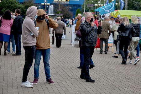 June 14 2020 Minsk Belarus In the black and white image an opposition blogger is broadcasting live among people walking down the streetのeditorial素材