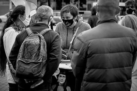 June 14 2020 Minsk Belarus A masked woman is campaigning for masked people to sign up for a presidential candidateのeditorial素材