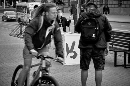 June 14 2020 Minsk Belarus There is a place for collecting signatures, where there is a woman in a mask.People are walking aroundのeditorial素材