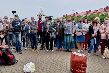 June 7 2020 Minsk Belarus Rally, when masked people stand near packages to collect moneyのeditorial素材