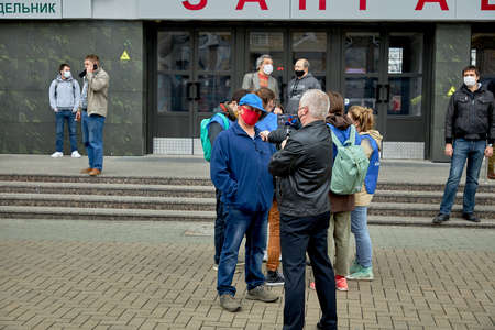June 14 2020 Minsk Belarus An opposition blogger leading a live broadcast asks a man in a red mask on the streetのeditorial素材
