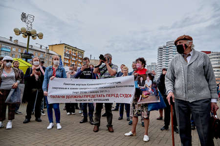 June 7 2020 Minsk Belarus The opposition leader masked near people with a large placard says into the microphone in protestのeditorial素材