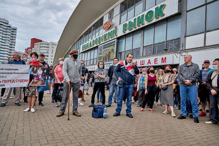 June 7 2020 Minsk Belarus Masked people with a large placard stand during a protest in the city square.The opposition leader says into the microphone in protestのeditorial素材