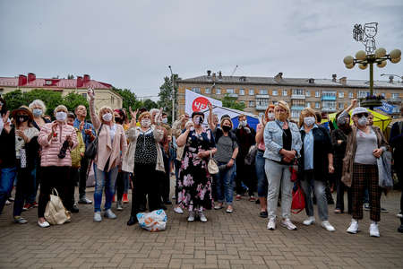 June 7 2020 Minsk Belarus A rally where masked people with their hands raised stand near a package to collect moneyのeditorial素材