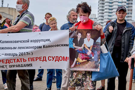 June 7 2020 Minsk Belarus An elderly woman shows a poster of her murdered husband at a protest in the squareのeditorial素材