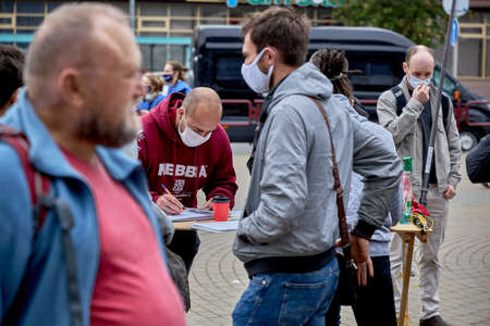 June 14 2020 Minsk Belarus A man casts his vote for an opposition candidate for the post of President of the Republic of Belarusのeditorial素材