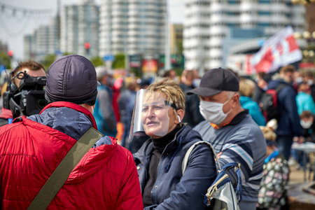 May 24 2020 Minsk Belarus Collecting signatures for opposition candidates, where a Press woman with a camera and microphone asks people questionsのeditorial素材