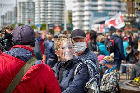 May 24 2020 Minsk Belarus Collecting signatures for opposition candidates, where a female reporter with a camera and microphone asks people questionsのeditorial素材