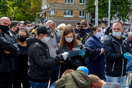 May 24 2020 Minsk Belarus Masked people massively fill out subscription lists for alternative presidential candidatesのeditorial素材