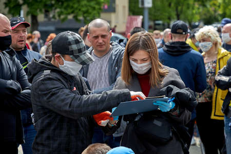 May 24 2020 Minsk Belarus Masked people fill out subscription lists for alternative presidential candidatesのeditorial素材