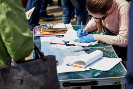 May 24 2020 Minsk Belarus Close-up of a woman writing out data from her passport to sign for a presidential candidateのeditorial素材