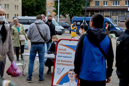 June 14 2020 Minsk Belarus A masked woman from the presidential candidate's initiative group sits at a table and accepts signaturesのeditorial素材