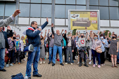 June 7 2020 Minsk Belarus The leader of the opposition with a microphone speaking at a protest rally in Minsk together with people raises his hands upのeditorial素材