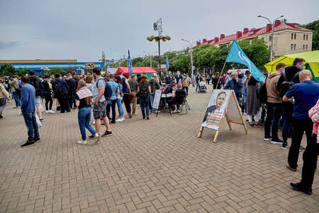 June 7 2020 Minsk Belarus Many people walk next to a poster of someone who wants to run for Presidentのeditorial素材