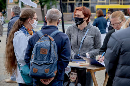 June 14 2020 Minsk Belarus A masked woman talks to masked people to sign up for a presidential...