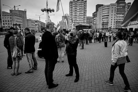 June 14 2020 Minsk Belarus In the black and white image a blogger interviews a presidential candidate against a background of people with opposition flagsのeditorial素材