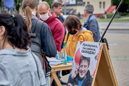 June 14 2020 Minsk Belarus A masked man and woman record votes for opposition candidates for the post of President of the Republic of Belarusのeditorial素材