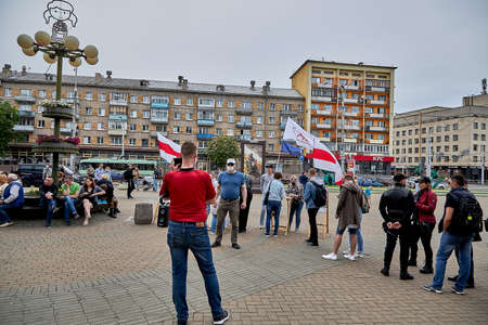 June 7 2020 Minsk Belarus A man is photographed against the background of people standing in line to vote for a presidential candidateのeditorial素材