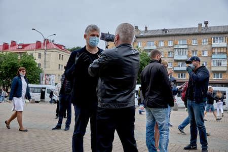 June 14 2020 Minsk Belarus Portrait of a masked man meeting a blogger among people at a protestのeditorial素材