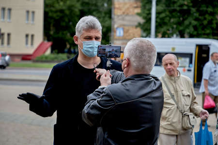 June 14 2020 Minsk Belarus Portrait of a masked man answering a blogger's questions at a protestのeditorial素材