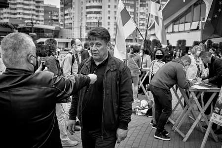 June 14 2020 Minsk Belarus Man shoots video of the presidential candidate at the table to collect signaturesのeditorial素材