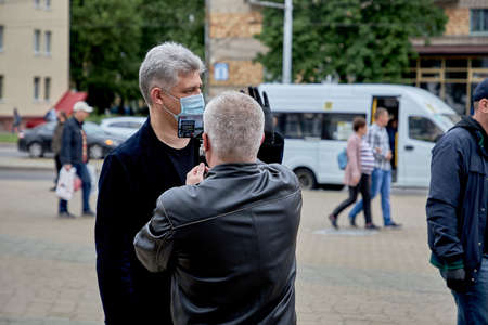 June 14 2020 Minsk Belarus There is a portrait of a masked man answering questions from a blogger during a protestのeditorial素材