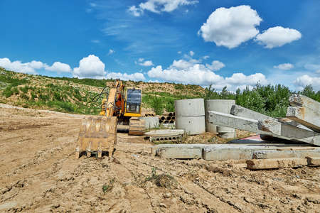 Close-up of a concrete well covered in a pipe-laying trenchの写真素材