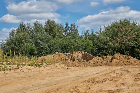 Sand lying for construction purposes against the blue skyの写真素材