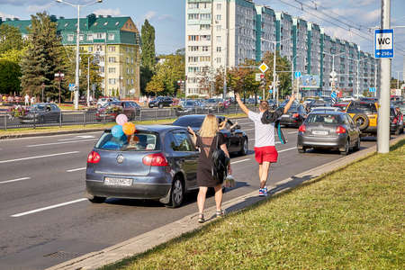 August 15 2020 Minsk Belarus A couple with their hands raised in protest are walkingのeditorial素材