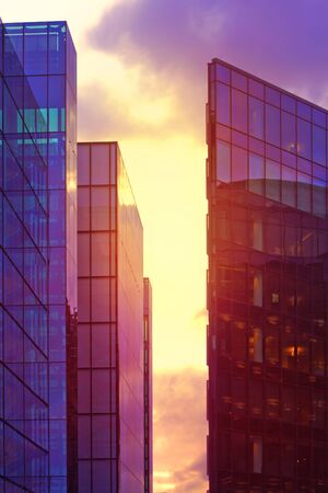 Modern buildings in London at purple sunset. Financial district and office building in London,...
