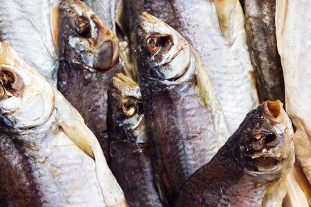 Dried, smoked, small fish used in Asian cuisine. Cooked sprat fish background or pattern....