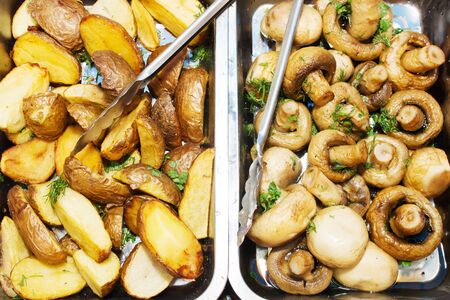 Potatoes, mushrooms roasted on BBQ grill. Grilled potatoes, mushrooms. Grilled vegetables with mushrooms on food festival.の写真素材