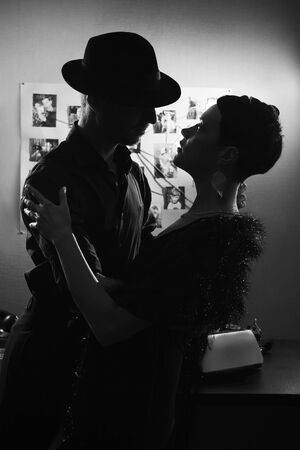 Film noir: romantic loving couple embracing in the dark, 1950s styleの写真素材