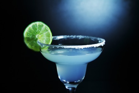 margarita cocktail with lime and salt. glass of margarita alcoholic cocktail on black backgroundの写真素材