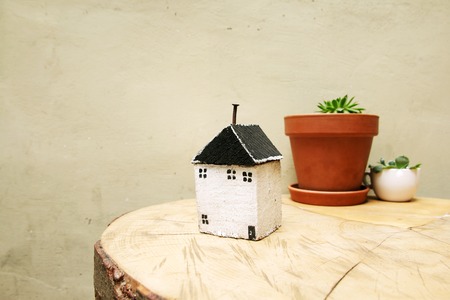 model of house as symbol on wall backgroundの写真素材