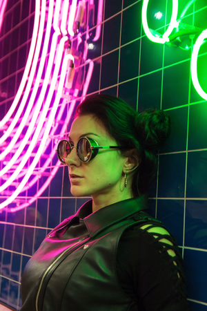 Cinematic night portrait of girl and neon lights in night clubの写真素材