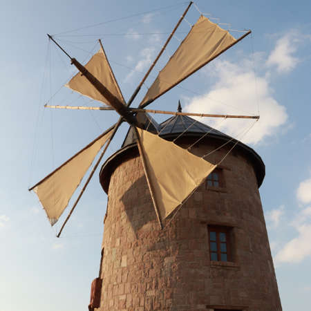 stone windmill and clouds at sunset