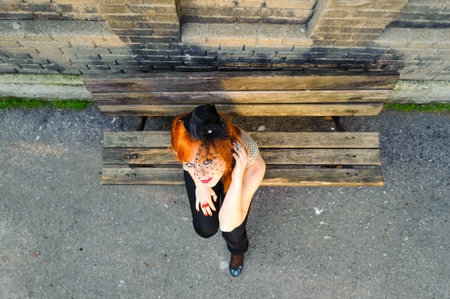 Red haired young girl with tulle mask hat top shot 